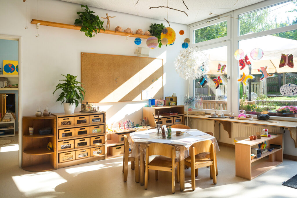 classroom with natural light, wooden furniture, and hands-on learning materials for children