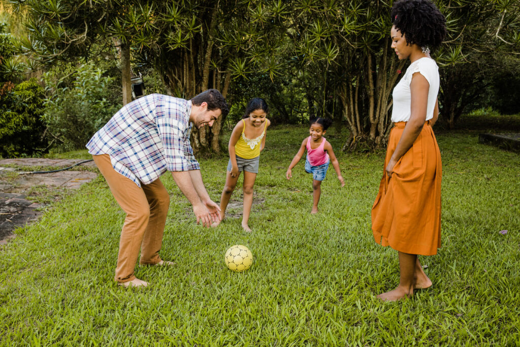 a family of four in a park playing with a ball in the best place to live in Germany with family