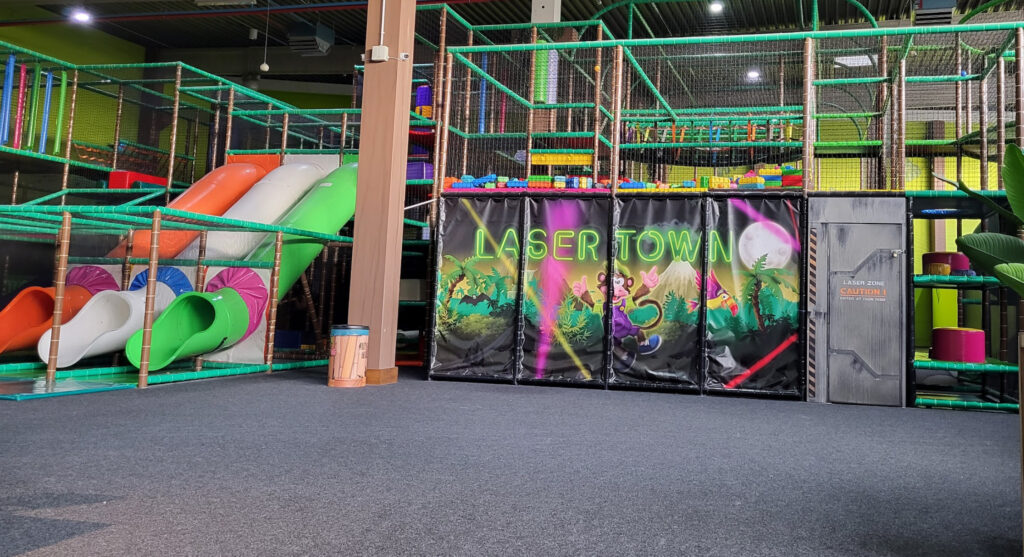 Indoor playground in NRW with laser tag zone, multi-level climbing frames, and colorful slides for children