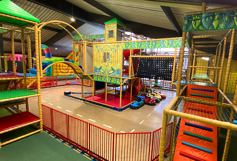 Indoor activity center in NRW with jungle-themed climbing structures, go-kart track, and adventure play zones for children