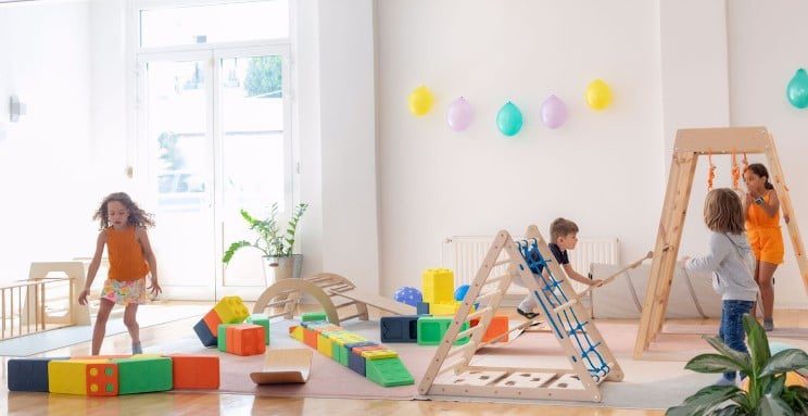 Practicing balance and focus during Montessori-style gross motor development activities, supporting holistic child growth.

