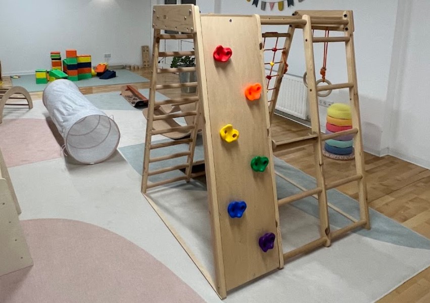 Wooden climbing structures and soft mats used in gymnastics for kids and toddler motor skills training