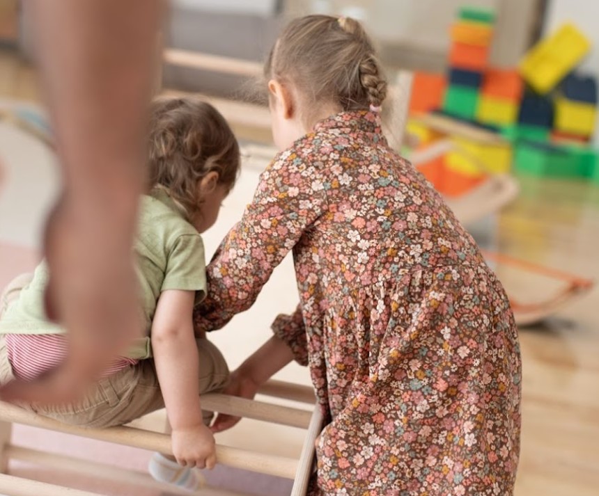 Mixed-age peer interaction exemplifying the mentorship model of Montessori philosophy in cooperative learning settings.

