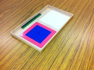 Montessori metal inset tracing tray for developing fine motor control and writing readiness, an essential pre-writing activity in the Montessori method of teaching reading and writing.

