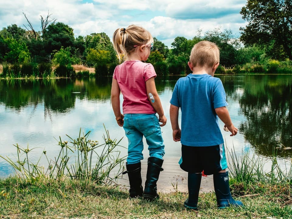 Montessori outdoor play encourages observation and nature exploration by the water’s edge.