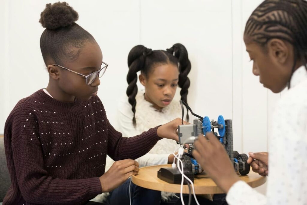 Montessori science activity with children assembling a robotic machine, encouraging hands-on learning and early scientific thinking