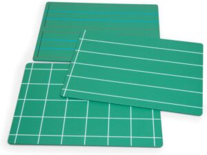 Montessori green chalkboards with lined grids used for handwriting practice and letter formation, aiding the transition from pre-writing to fluent writing.

