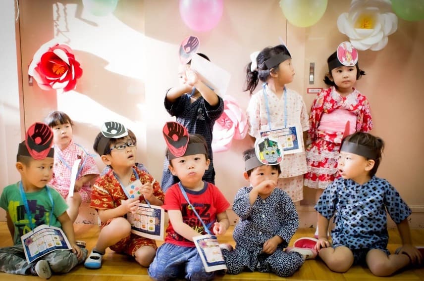 Group of young children in a classroom setting wearing costumes, highlighting diverse experiences in Montessori education and addressing common parent concerns.

