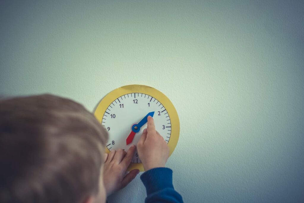 illustrative image for the "Is Montessori good for ADHD" guide: Child using a learning clock to tell time — representing Montessori’s real-life, self-paced learning approach for ADHD support