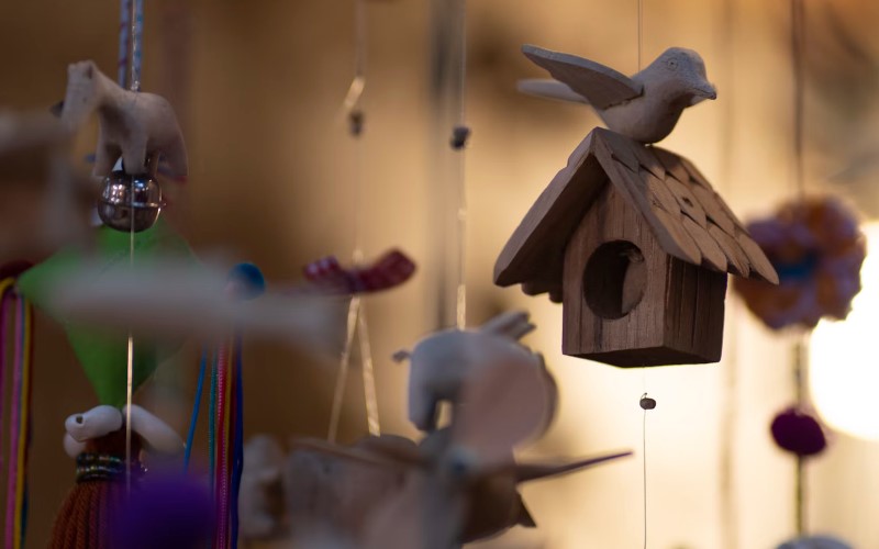 Handmade wooden mobile for sensory development in a Montessori-inspired nursery
