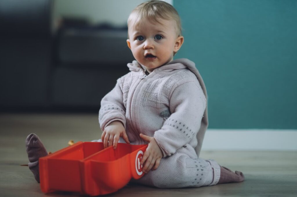 Baby exploring independently in a thoughtfully arranged Montessori baby room layout