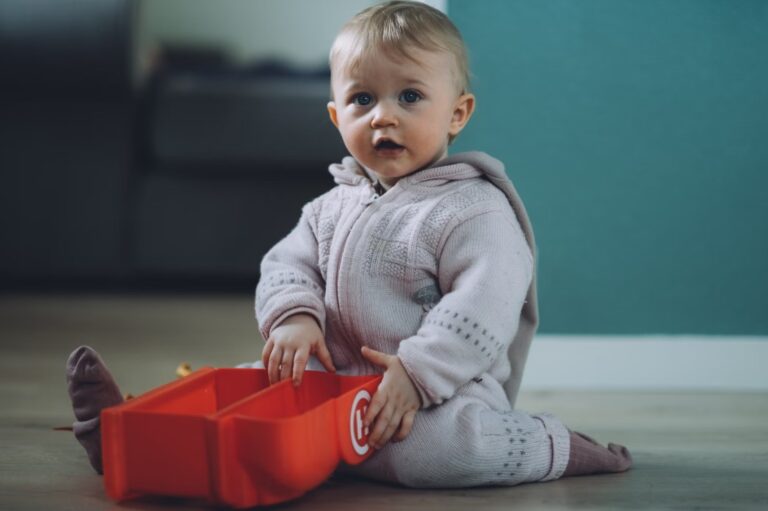 Baby exploring independently in a thoughtfully arranged Montessori baby room layout