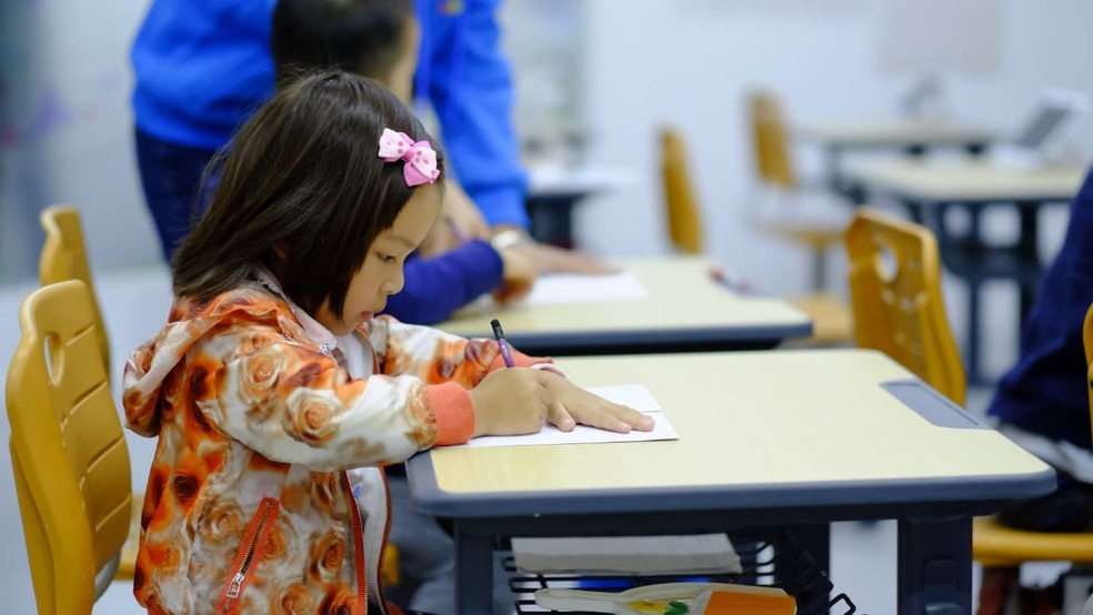 Young child drawing at a desk in a preschool environment — early childhood education in Germany in action.