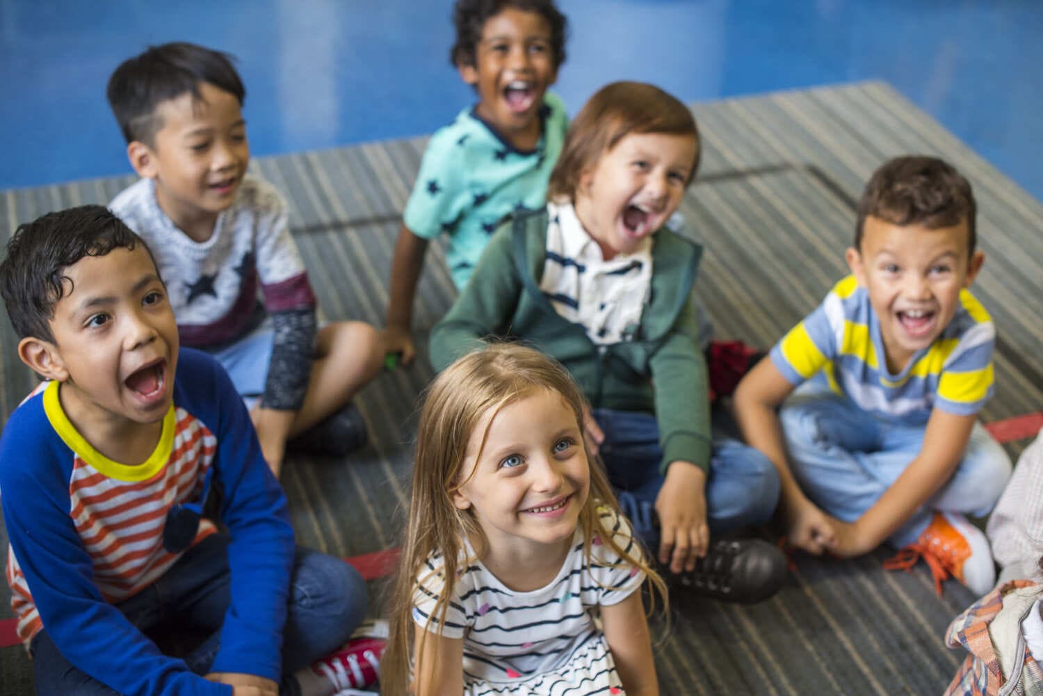 Illustrative image for the Montessori guide with 6 happy kids in a classroom