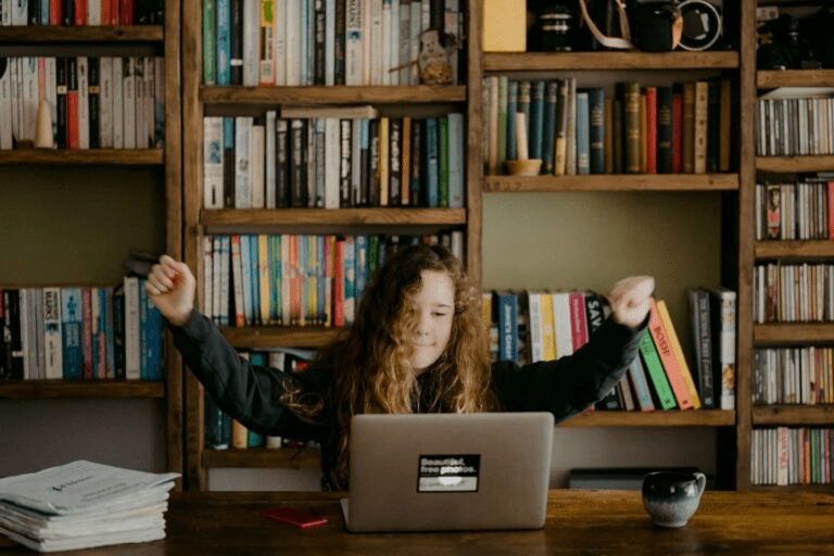 a girl in front of a laptop doing coding 