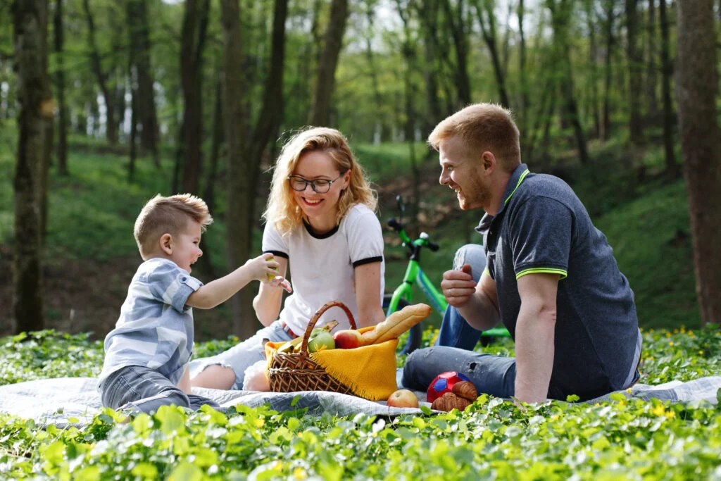 Family enjoying a picnic in the woods 
