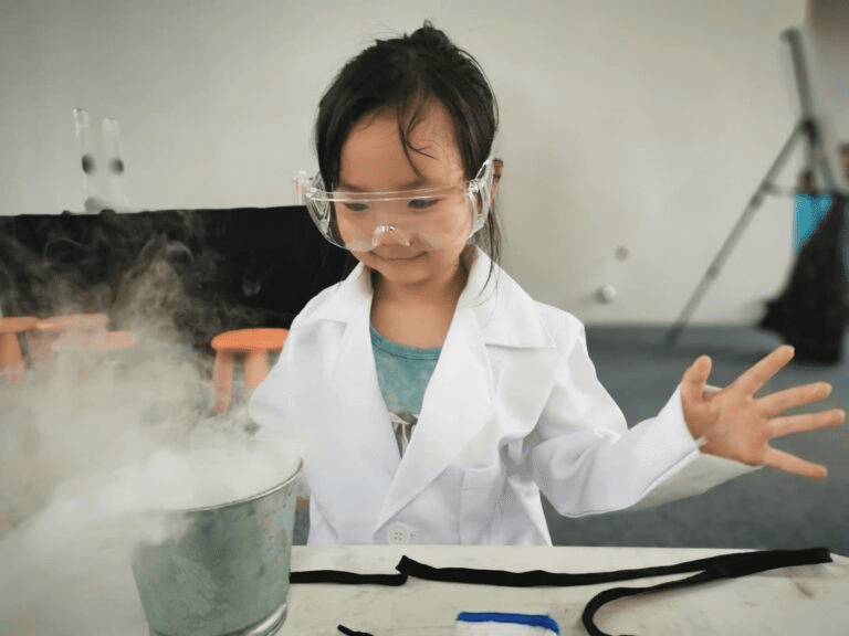 A child doing science experiments in a classroom - a part of a Montessori curriculum