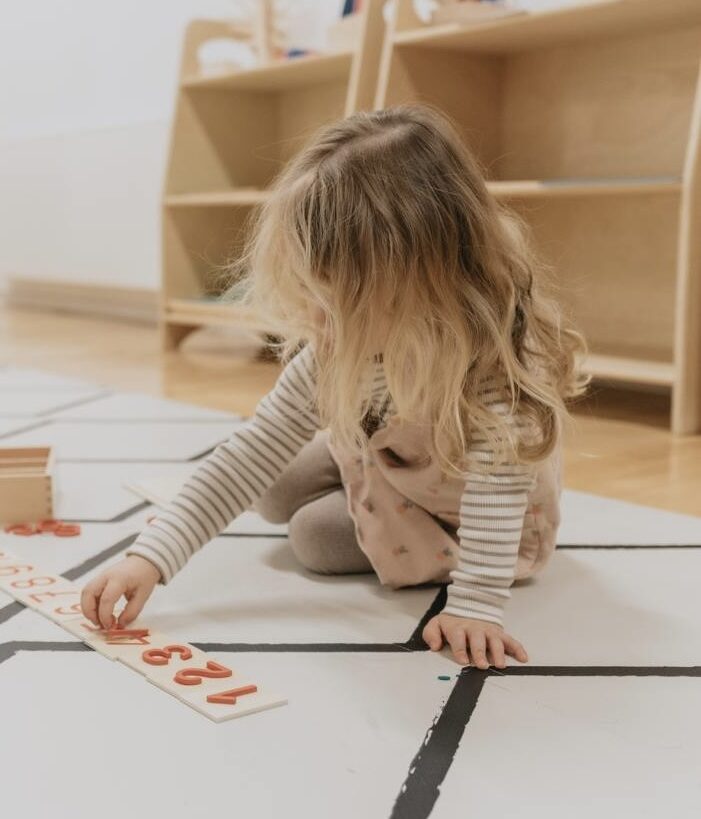 Child learning with Montessori materials as part of family-friendly coworking space at Montessori Family Center in Düsseldorf