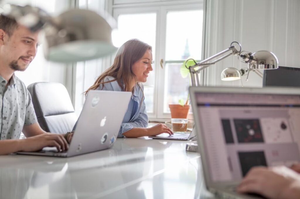 Two people working in a coworking space Düsseldorf near the window