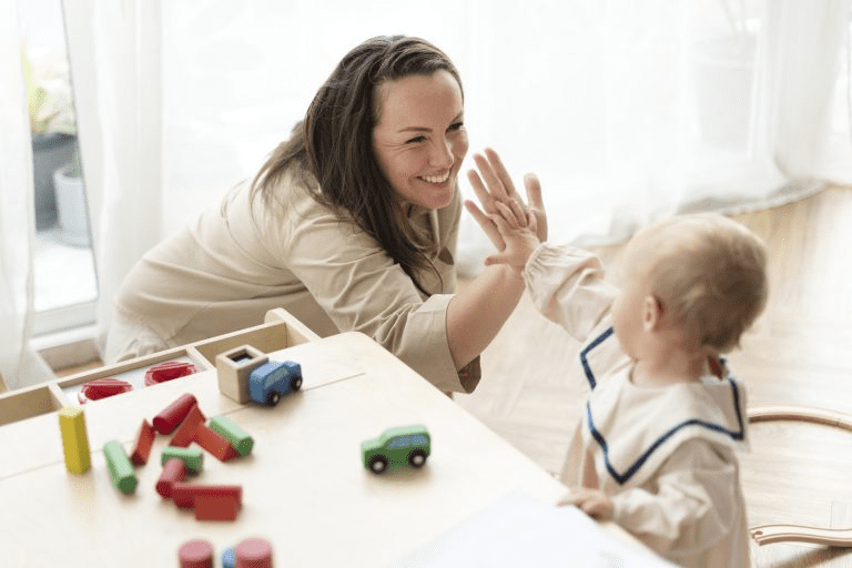 Child giving high five to their mother
