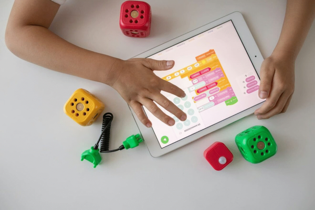Child interacting with Montessori-friendly codding app on a tablet and toys