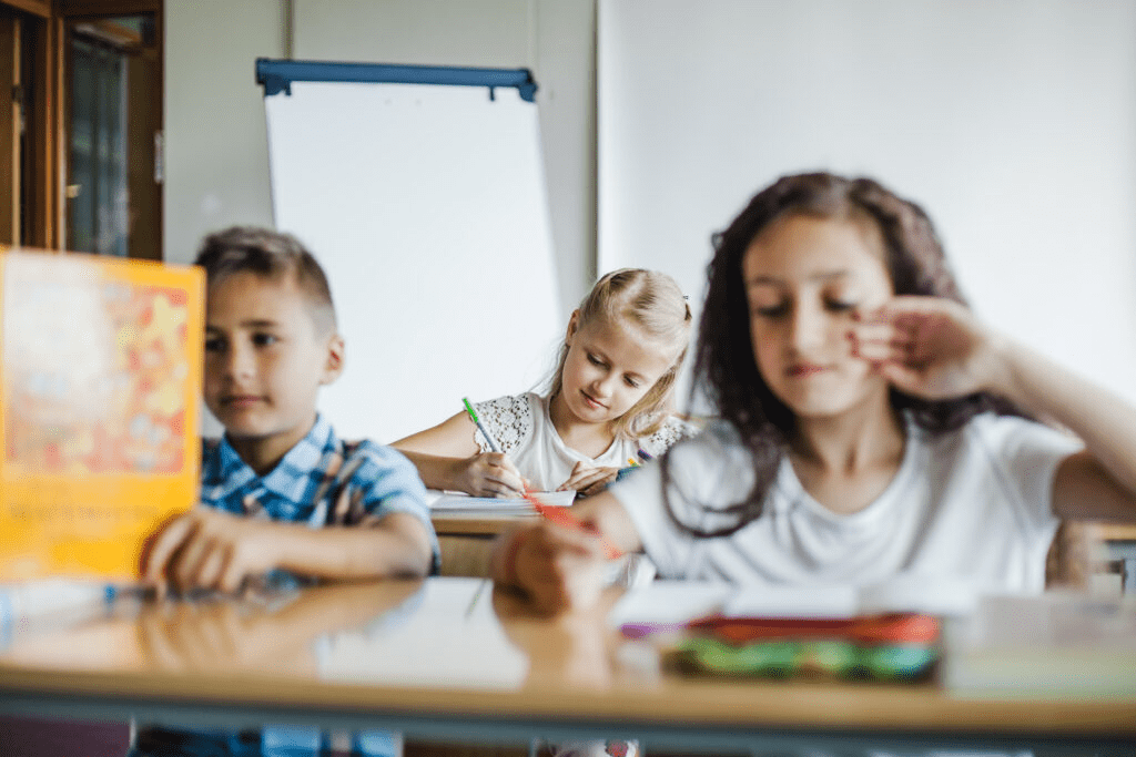 n in a traditional classroom sitting at desks during a lesson